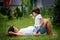 Beautiful young pregnant woman and her older child, lying down i