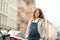 Beautiful young pregnant woman wearing casual clothes walking through the city streets. concept of motherhood and pregnancy.