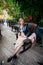 Beautiful young pregnant woman wearing dress and leather shirt resting in city park cafe, stylish pregnancy shot. Beautiful woman