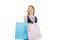 Beautiful young red-haired girl in a dress holds three packages on an isolated background, new purchases and gifts