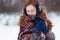 Beautiful young red-haired woman in blue headphones and gloves.