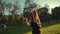 Beautiful young redhair female blowing and bursting soap bubbles outdoors.