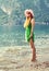 Beautiful young relaxing woman walking barefoot on beach on the sea