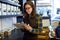 Beautiful young saleswoman doing inventory in a retail store selling coffee.