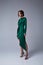 Beautiful young sexy woman thin slim figure evening makeup fashionable stylish dress clothing collection, brunette, green silk