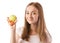 Beautiful young smiling woman holding an apple and measuring centimeter in hands