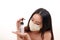 Beautiful young south east Asian woman three ply anti virus surgical face mask posing holding using squeeze transparent liquid