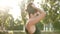 Beautiful young sport woman making hair tail ponytail slow motion. Female prepares for workout outdoor fitness training