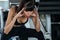 Beautiful young sport woman tired taking a break from exercise sitting on machine  in fitness gym . girl in sportswear workout