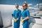 Beautiful young stewardesses standing on airplane stairs