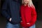 Beautiful young stylish couple in trendy hoodie indoors with sunshine. Hipster happy girl in red hoodie and handsome man