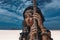 Beautiful young stylish tribal woman in oriental costume playing sitar outdoors. Close up