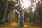 Beautiful young stylish woman with boho accessories and gem stone rings at sunset on the field