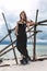 Beautiful young stylish womanin black dress on on the beach