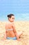 Beautiful young teenager girl practice yoga meditation summer sea beach