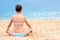 Beautiful young teenager girl practice yoga meditation summer sea beach