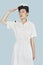 Beautiful young US Navy officer saluting over light blue background