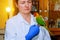 Beautiful young veterinarian feeding parrot in vet clinic