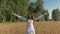 Beautiful young white woman singing with happiness on the field with wheat.