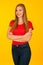 Beautiful young woma in red t shirt and jeans over yellow background