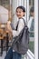 Beautiful young woman asian with backpack and book. College student carrying lots of books in college campus