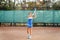 Beautiful, young woman athlete enjoys spending time on the tennis court. Powerful blow forehand. Preparing to receive the ball
