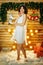 Beautiful young woman on the background of lights,dancing Christmas mood