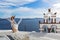 Beautiful young woman and bells on Santorini island