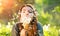 Beautiful young woman blowing dandelions