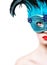 Beautiful young woman in blue carnival mask