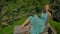 A beautiful young woman in a blue dress visits famous Tegalalang Rice Terraces in Ubud village on the Bali island