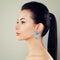 Beautiful Young Woman with Blue Earrings