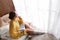 Beautiful young woman with book and cup of coffee near window at home. Winter atmosphere