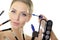 Beautiful young woman with brushes and cosmetics