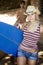 Beautiful Young Woman Carrying Surfboard