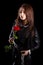 Beautiful young woman with chains and a red rose