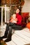 Beautiful young woman with a child on the front porch with pumpkins autumn. Smiling mother and son.