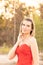 Beautiful young woman with clean perfect skin wearing a classy red evening dress. Portrait of beauty model with natural