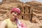 Beautiful young woman in colorful dress and kefiah enjoying at The Monastery, Petra`s largest monument, UNESCO World Heritage Sit