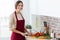 Beautiful young woman cutting fresh vegetables in the kitchen.