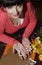 Beautiful young woman cutting gingerbread shapes from dough