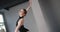 Beautiful young woman dancer in black stage dress with open back rehearses dance moves, ballet rehearsal, ballerina does