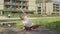 Beautiful young woman doing yoga outdoors near home