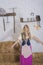 beautiful young woman, dressed in farmer outfit in barn with hay