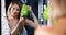 Beautiful young woman dries hair with a hairdryer combs and smiles