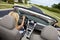 Beautiful Young Woman Driving Convertible Car