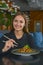 Beautiful young woman eating chinese food called Wok with chopsticks. Wok with meat and fried asparagus in a plate