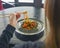 Beautiful young woman eating chinese food called Wok with chopsticks. Wok with meat and fried asparagus in a plate