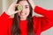 Beautiful young woman eating half fresh green kiwi stressed with hand on head, shocked with shame and surprise face, angry and