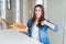 Beautiful young woman eating homemade tasty pizza at the kitchen with surprise face pointing finger to himself